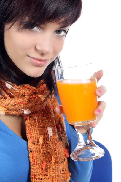 istock Beautiful young woman drinking juice 1133863170