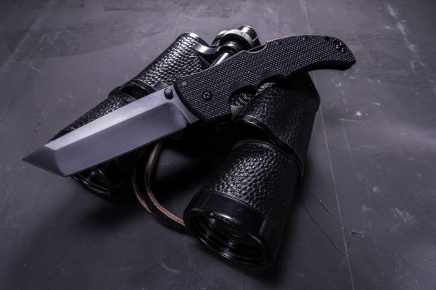 istock Big black knife and binoculars. American knife and Soviet binoculars. 1133863760