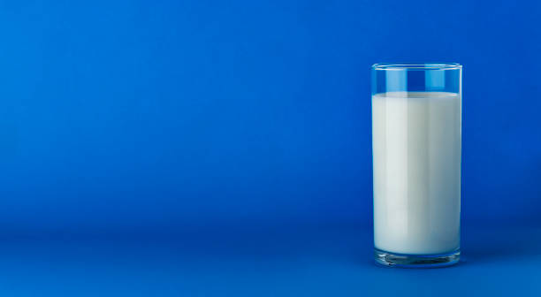 istock Glass of milk isolated on blue background with copy space 1133866211
