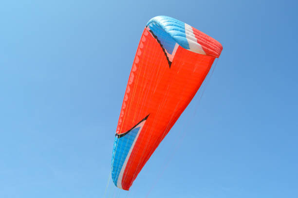 istock Parachute in blue clear sky 1133867960