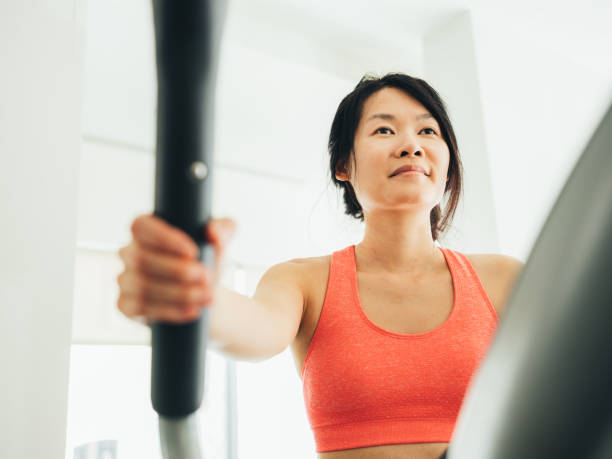 istock Young Asian woman working out 1133872916