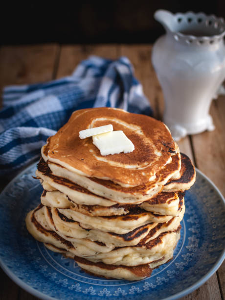 istock Stack of pancakes with butter on wooden background 1133875989