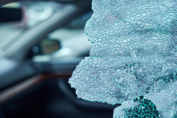 istock A criminal incident. Hacking the car. Broken left side window of a car 1133877566