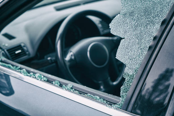 istock A criminal incident. Hacking the car. Broken left side window of a car 1133877571
