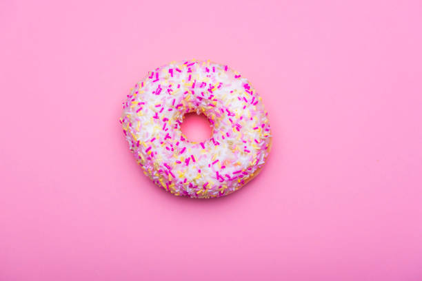 istock Donut with colorful sprinkles on a pink background 1133879058
