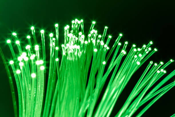 istock Bundle of optical fibers with green light. 1133879216