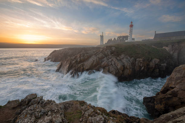 istock Lighthouse Pointe de Saint-Mathieu, sunset big waves, Brittany (Bretagne), France 1133879353