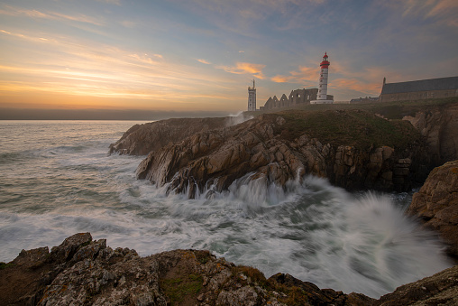 Lighthouse Pointe de Saint-Mathieu, sunset big waves, Brittany (Bretagne), France