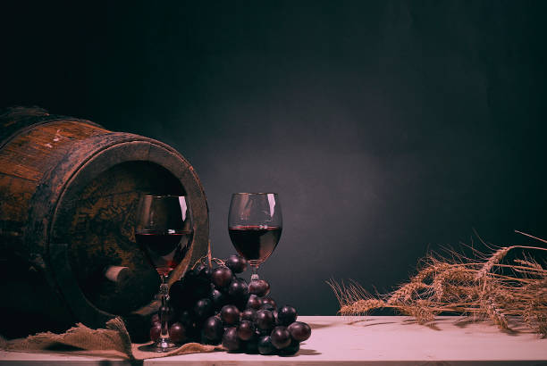 istock Red wine glass on wooden barrel 1133880531