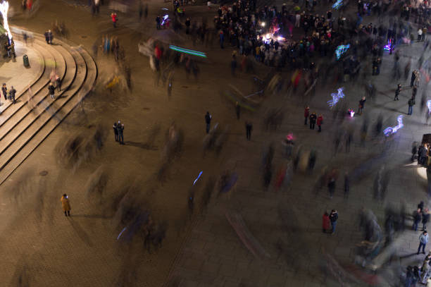 Crowded Main Pedestrian Square in Warsaw, Poland at Night Poland's capital Warsaw in winter. long exposure winter crowd blurred motion stock pictures, royalty-free photos & images