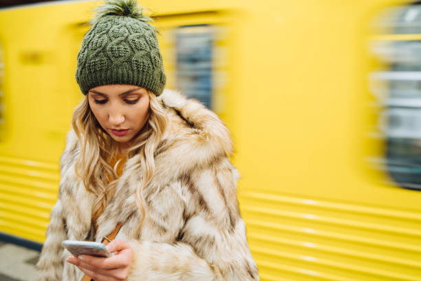 istock Woman using smart phone in subway 1133885284