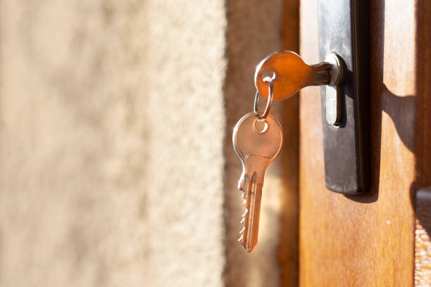istock Keys from a new house. keys in a door. 1133887489