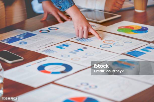 Paperwork And Hands On A Board Room Table At A Business Presentation Or Seminar Stock Photo - Download Image Now