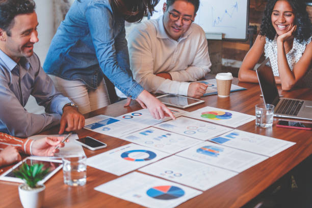 istock Paperwork and hands on a board room table at a business presentation or seminar 1133887504