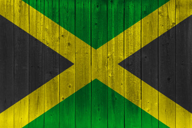 Jamaica flag painted on old wood plank. Patriotic background. National flag of Jamaica