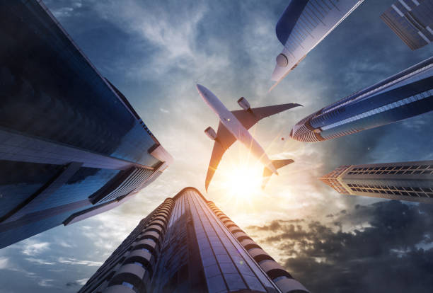 Commercial airplane flying above skyscrapers. Concept of modern technologies, business and fast travel.