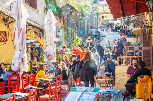 March 1, 2019. Athens, Greece, Plaka area in the morning, people relaxing at traditional street cafe on a stairway