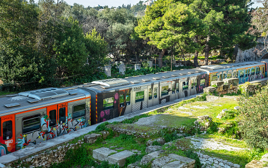 March 1, 2019. Athens, Greece, historic center, Plaka area, Electric railway locomotive on the tracks, green nature background