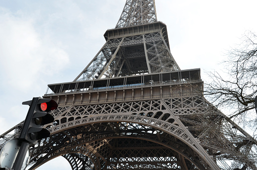 First and Second floors of the Eiffel Tower with a stop light in the foreground. Copy Space.