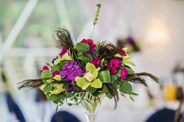 istock Vase with flowers on a served round table, dinner in a luxurious restaurant. 1133896099