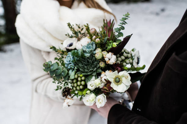 istock The bride and groom holding a wedding bouquet in rustic style. 1133896946