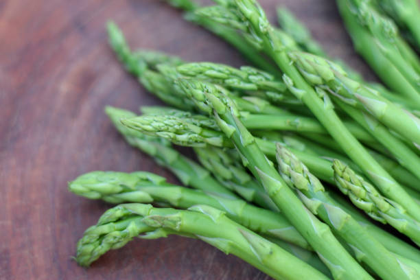 istock Raw asparagus. Fresh Asparagus on wooden background 1133905050