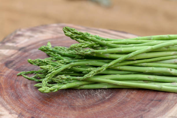 istock Raw asparagus. Fresh Asparagus on wooden background 1133905056