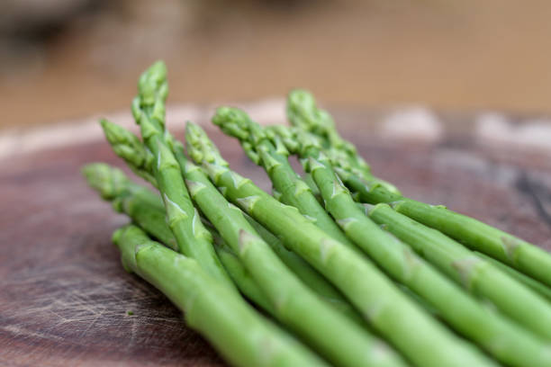 istock Raw asparagus. Fresh Asparagus on wooden background 1133905349