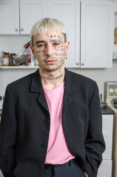 istock Young tattooed man posing in his kitchen 1133906689