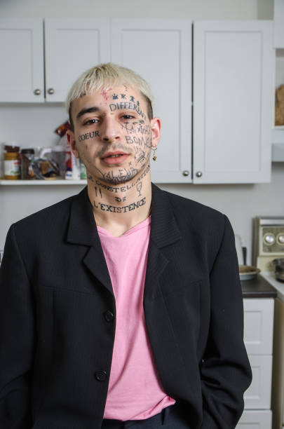 istock Young tattooed man posing in his kitchen 1133908323