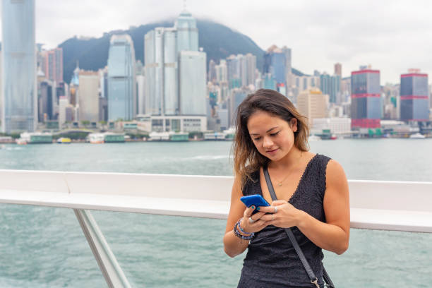 istock Asian Woman Using a Mobile Phone in Hong Kong 1133909976