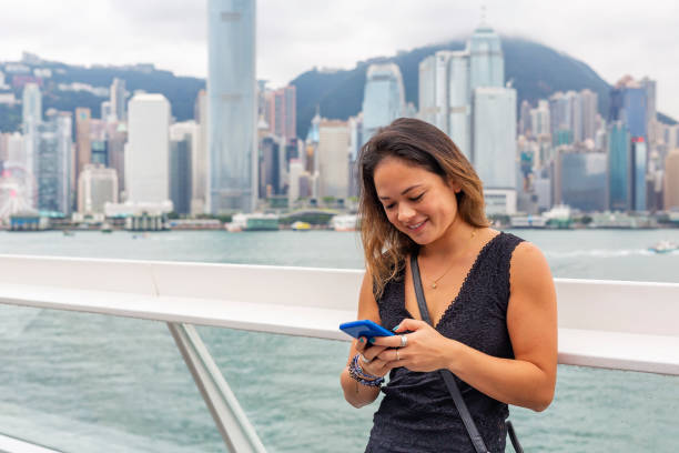 istock Asian Woman Using a Mobile Phone in Hong Kong 1133909977