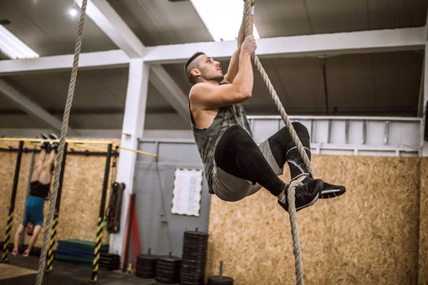 istock Athlete Man Climbing Gymnastic Rope 1133911108