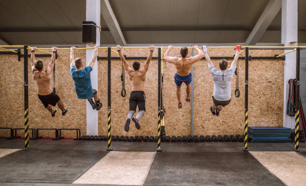 istock Young Men Doing Chin Ups In Gym 1133911182
