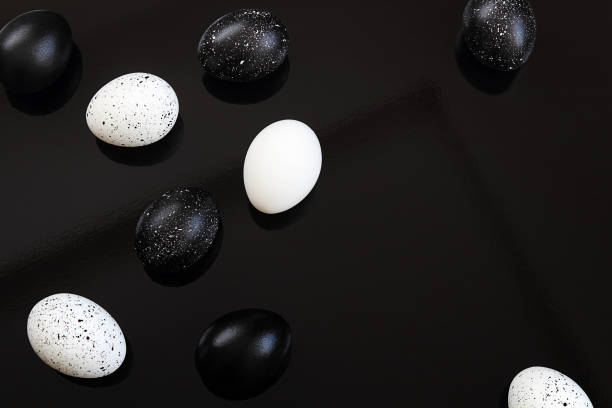 istock Easter. Easter eggs, black and white on a black background. Selective focus, macro, toning, blur. 1133913664