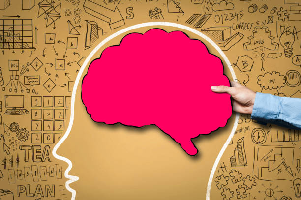 istock Businessman holding brain shape panel, on yellow board with chaotic charts (Click for more 1133914060