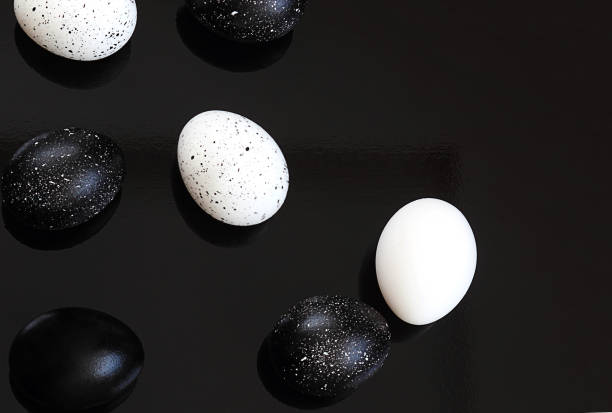 istock Easter. Easter eggs, black and white on a black background. Selective focus, macro, toning, blur. 1133916612