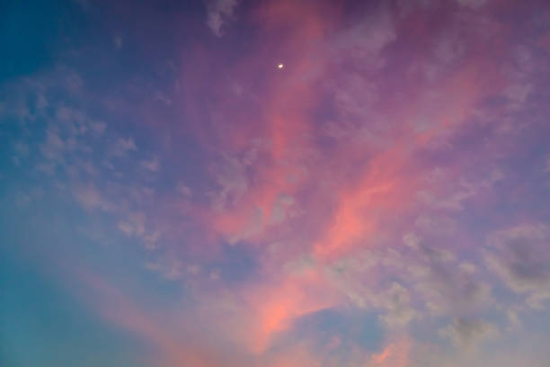 istock White moon on colorful vivid pink and blue twilight sky. 1133918459