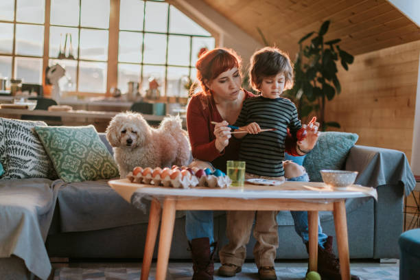 Coloring Eggs For Easter Mother And Son Enjoying Creative Day In Easter Egg Coloring breed eggs stock pictures, royalty-free photos & images