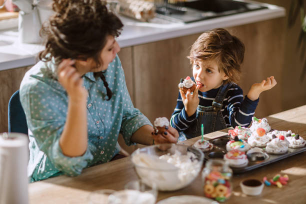 istock Mom And Son Tasting Birthday Muffins 1133918911