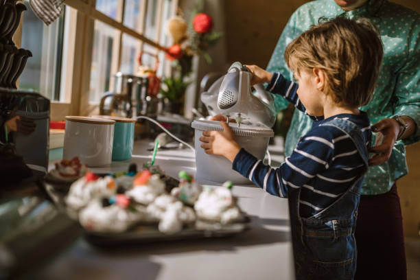 istock Boy Helping His Mother Mixing Whipped Cream 1133918930