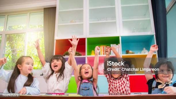 Group Of Multiethnic Five Little Kids Children African American Asian And Caucasian Happiness Together With Friend To Draw Colour Pencil To Full Colour Of Picture In Living Room Or Class Room Stock Photo - Download Image Now