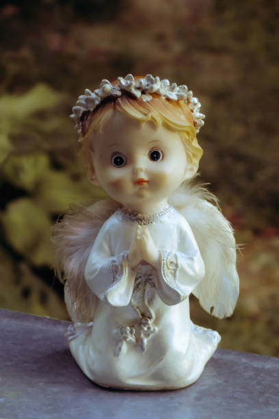 istock Cute praying Angel on the window at home. Religious background. 1133921277