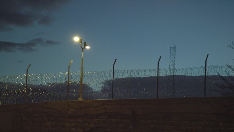 Barbed Wire Fencing at Dusk Surrounding the United States Penitentiary, Administrative Maximum Facility Supermax Prison Complex in Florence, Colorado (Fremont County) - the 