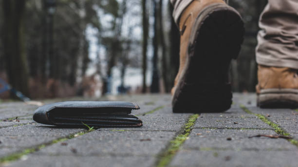 istock Man walking away from lost wallet 1133927135
