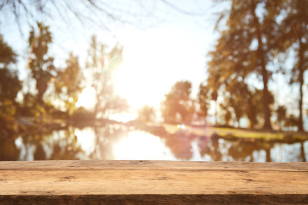 istock Wood Table Top on Blurred Tropical Background 1133928943