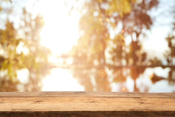 istock Wood Table Top on Blurred Tropical Background 1133928948