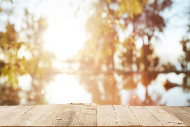 istock Wood Table Top on Blurred Tropical Background 1133928954
