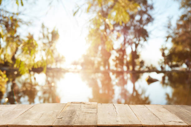 istock Wood Table Top on Blurred Tropical Background 1133928955