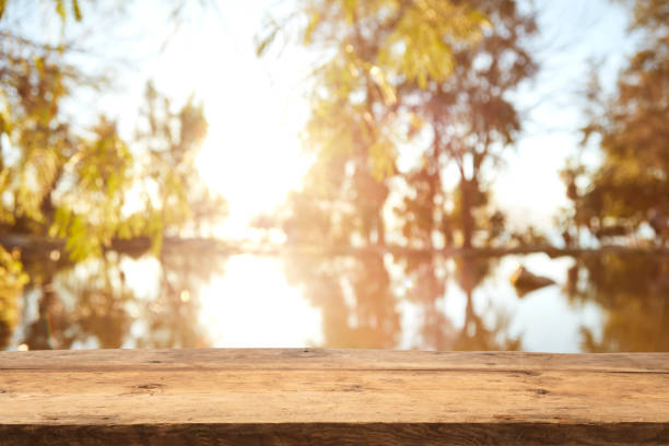 istock Wood Table Top on Blurred Tropical Background 1133928959